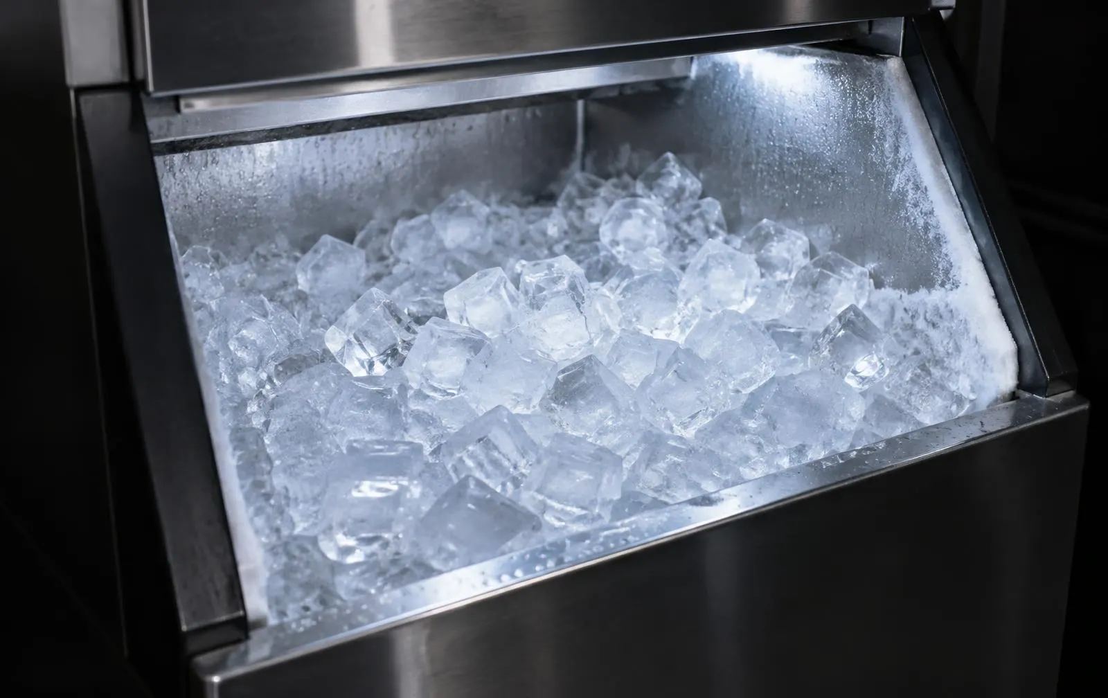Commercial ice machine bin filled with clear ice cubes